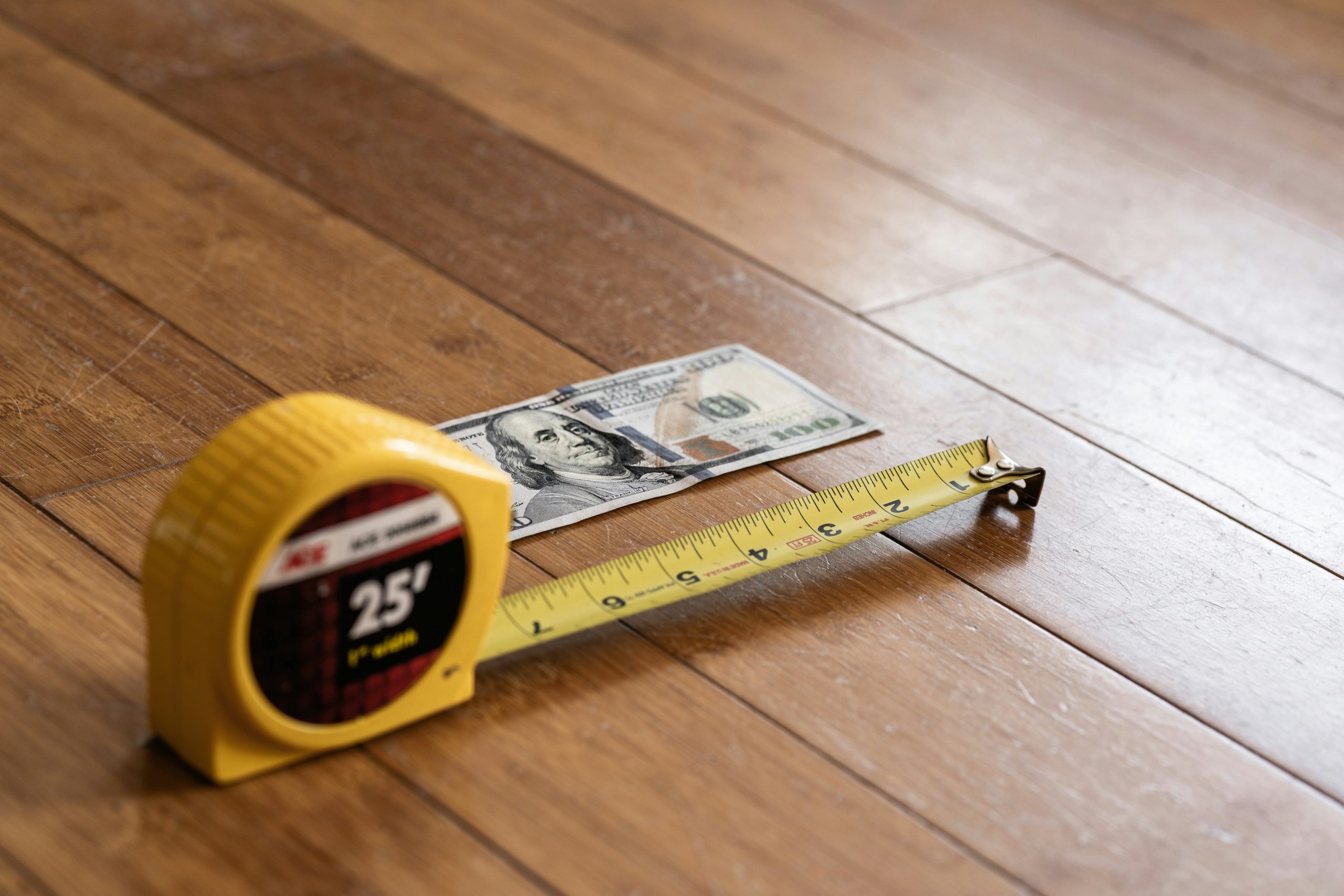 tape measure next to dollar bill